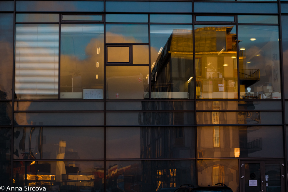 reflecting Copenhagen cityscape in a glass building